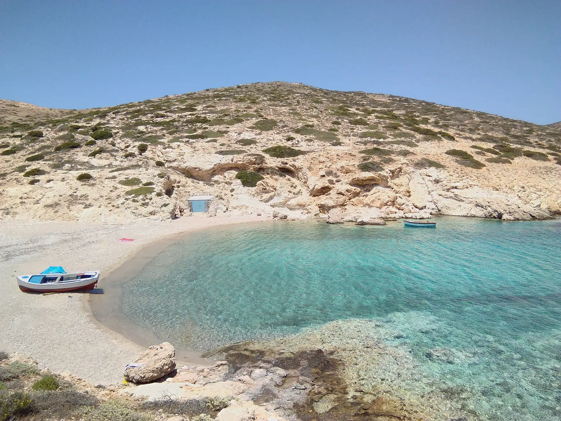 View of Kalotaritissa beach on the beautiful Greek island of Donousa. A deserted shingle beach in a quiet bay, on a summers day.
